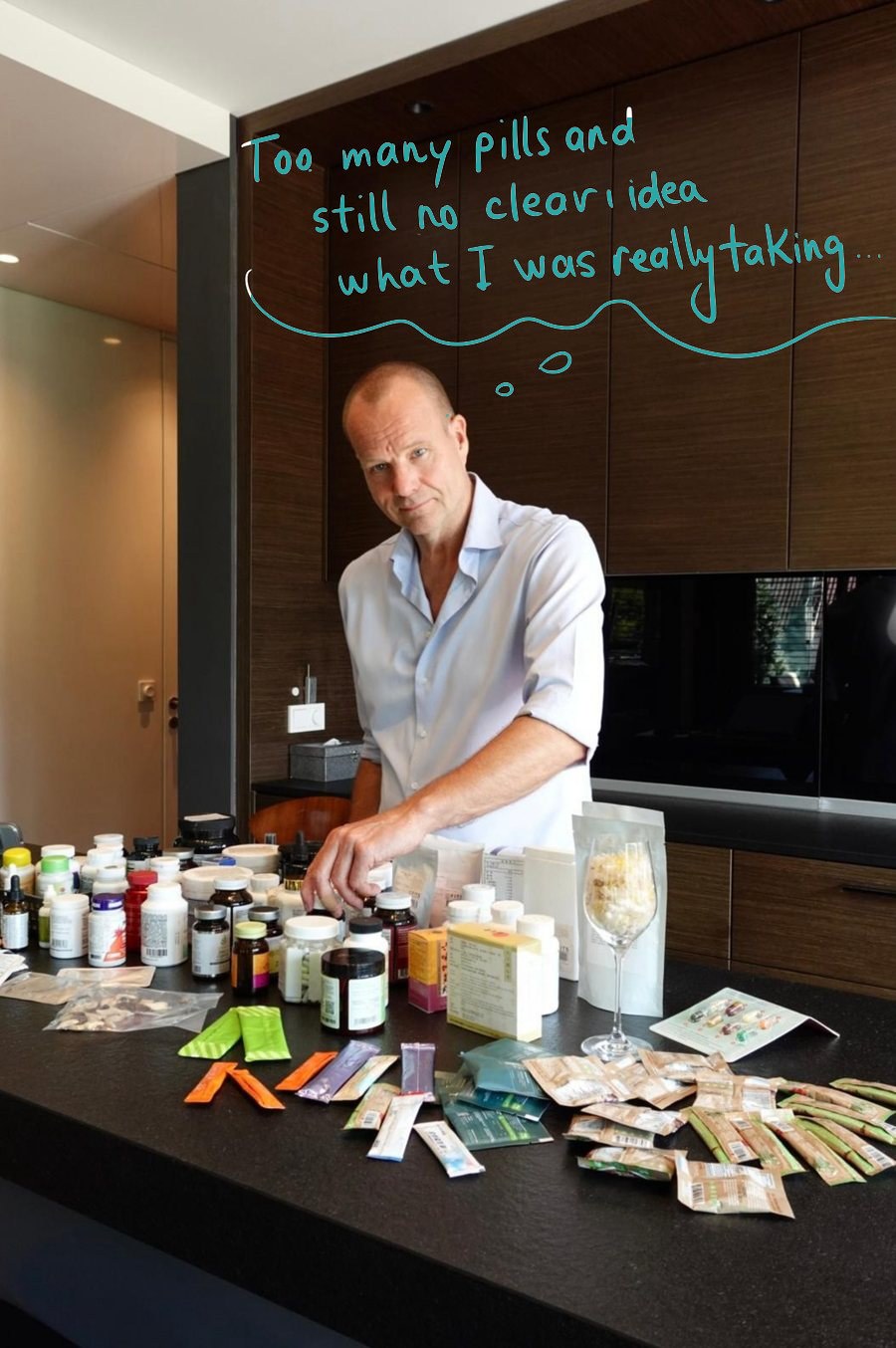 Kristjan Kann at his kitchen table covered with supplement bottles